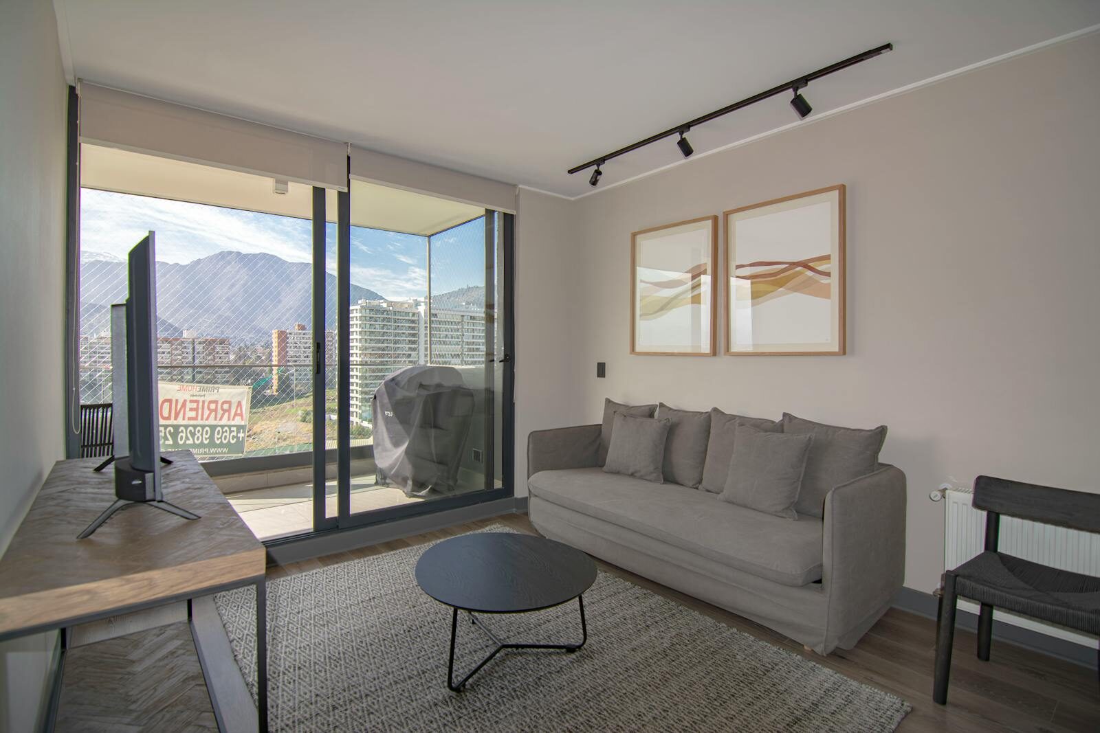 Contemporary living room featuring a cozy sofa, stylish decor, and stunning mountain view.